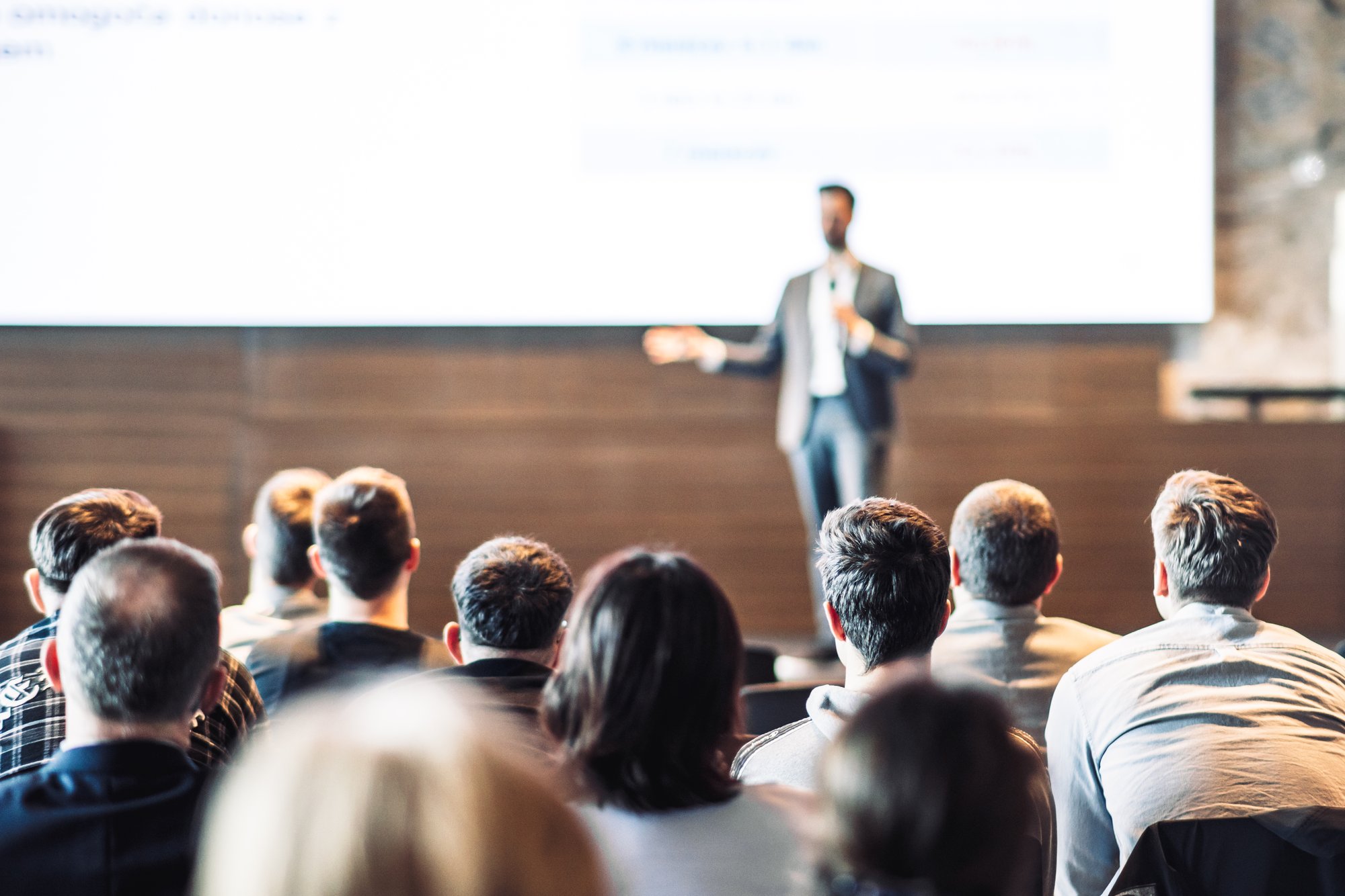 speaker-giving-talk-conference-hall-business-event-rear-view-unrecognizable-people